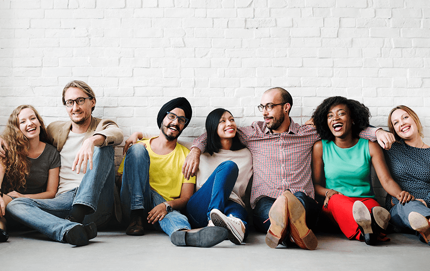 Young international students smile as they discuss the cheapest international student health insurance option.